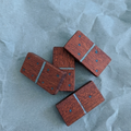 Domino de madera de iroko y resina azul hecho a mano por Siete Maderas en su taller de Málaga.