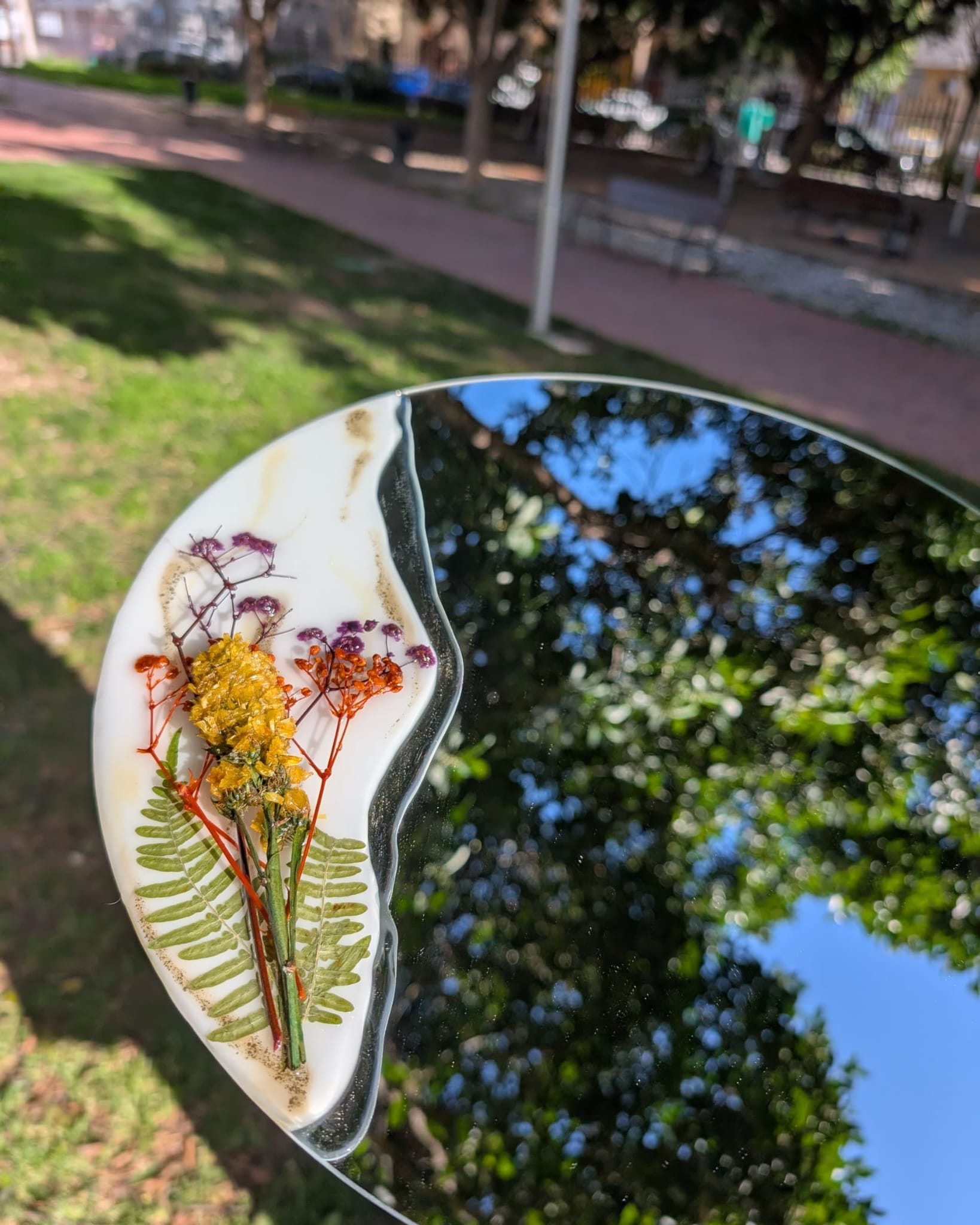 Proceso de creación en el taller de espejo intervenido con resina y flores secas y preservadas por Siete Maderas. Diseño único con base blanca y dorada. Flores silvestres. 